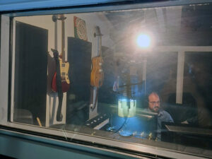 recording studio seen through glass of recording booth