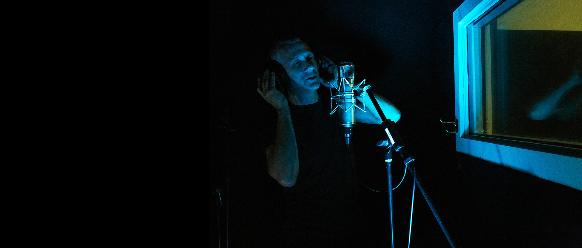 Recording vocals in an isolated vocal booth in studio