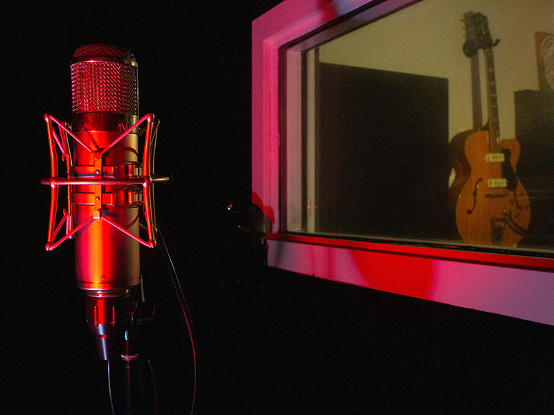 Condenser mic and guitar on wall