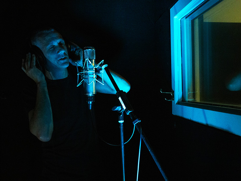 Man recording through high quality microphone at West Auckland studio